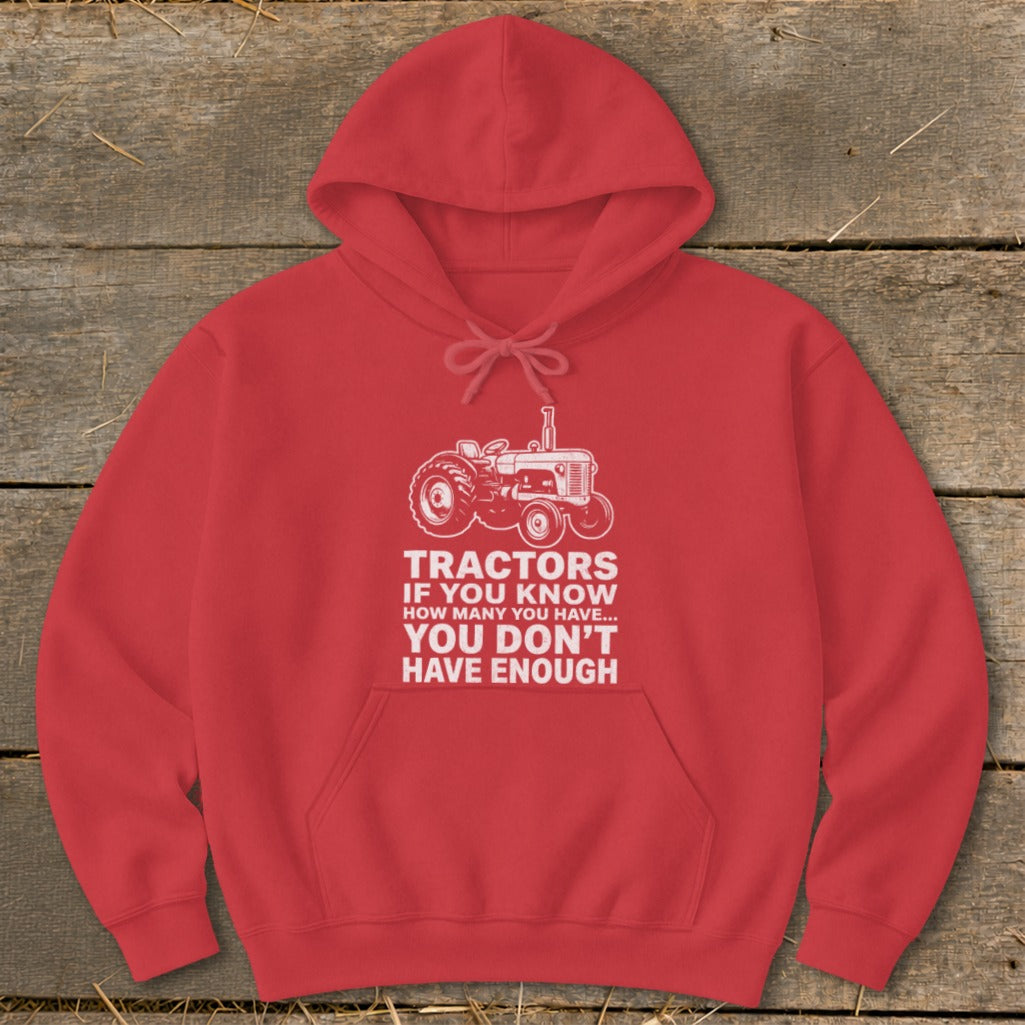 Red hoodie with a tractor graphic and text: "Tractors if you know how many you have... you don't have enough."