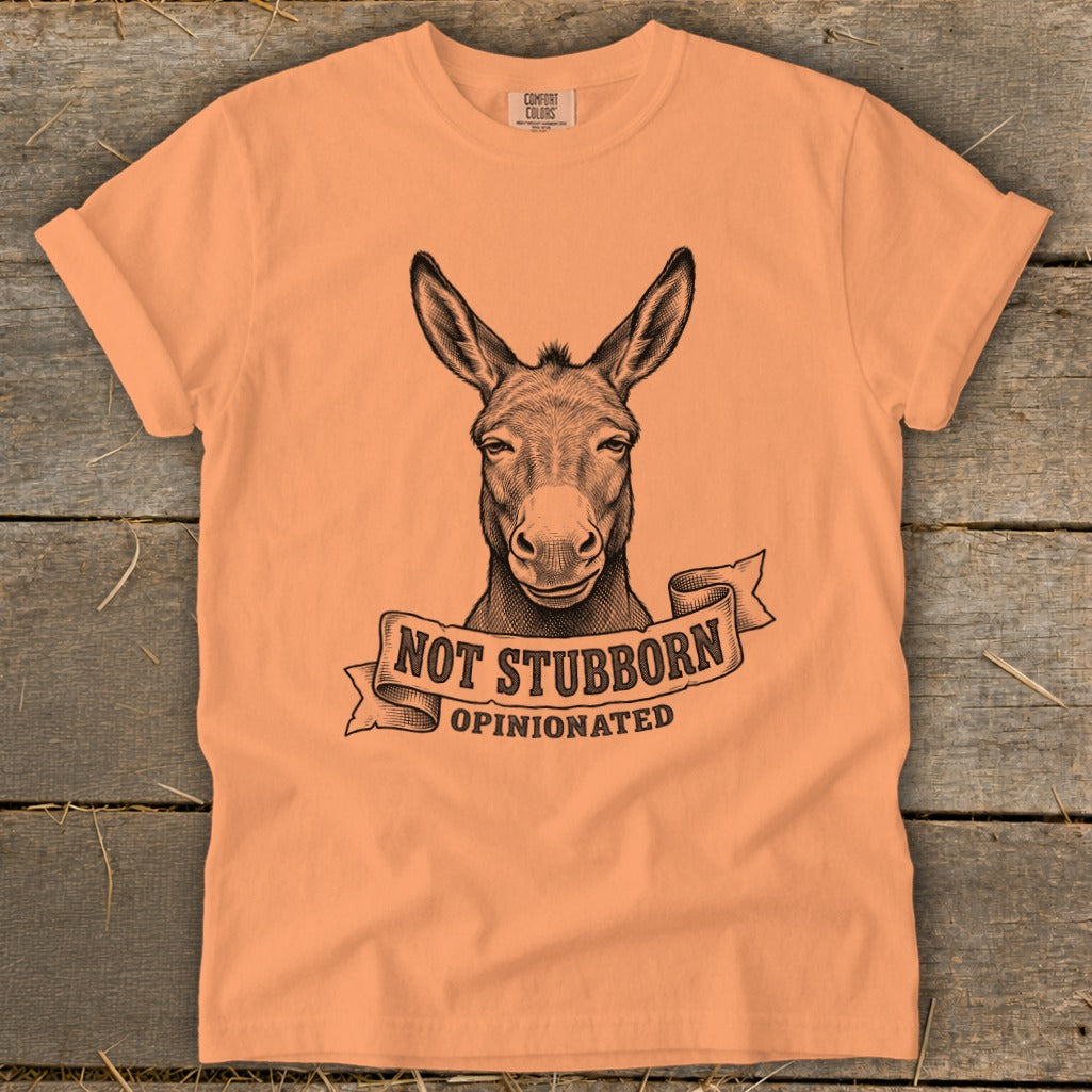 Peach t-shirt with a donkey graphic and text "NOT STUBBORN OPINIONATED".