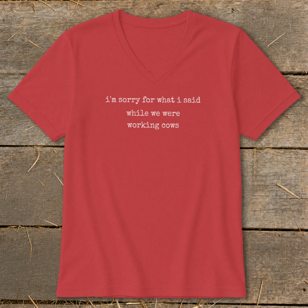Red v-neck t-shirt with white text: "i'm sorry for what i said while we were working cows."
