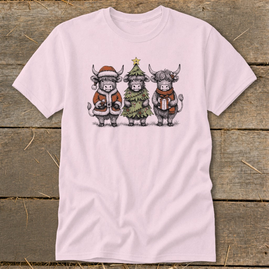 Three Highland cows dressed for holidays on a pink t-shirt.