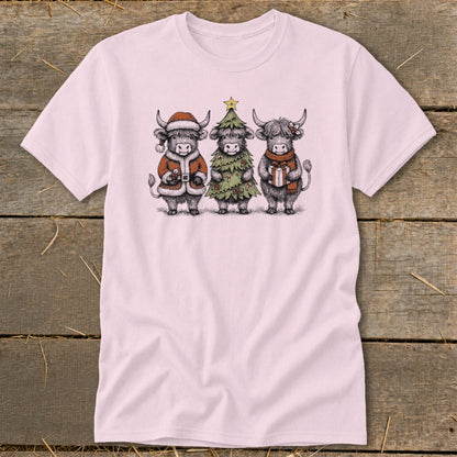 Three Highland cows dressed for holidays on a pink t-shirt.