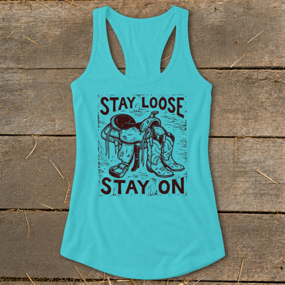 Turquoise tank top with a graphic of a saddle and cowboy boots with text.