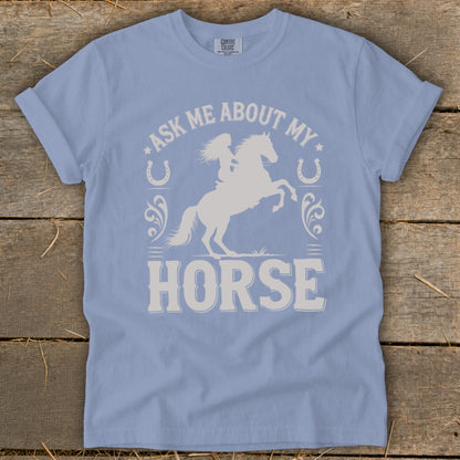 Light blue t-shirt with white graphic: "Ask Me About My Horse" and equestrian silhouette.