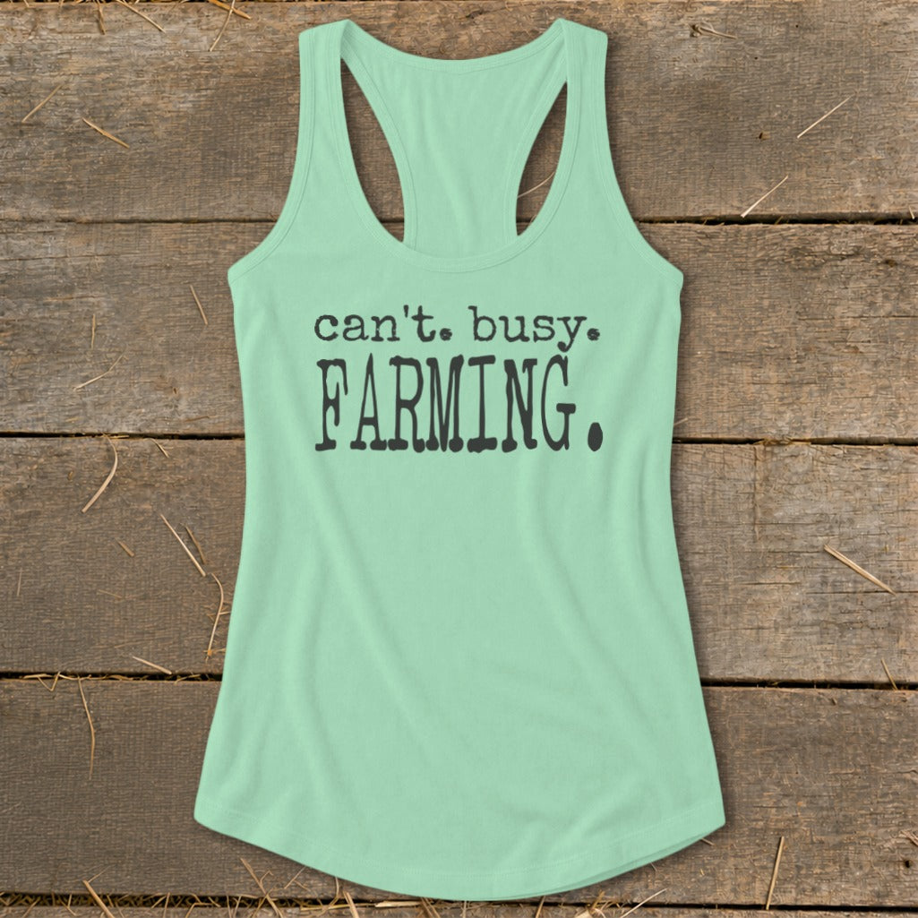Mint green racerback tank top with "can't. busy. FARMING." text in black.