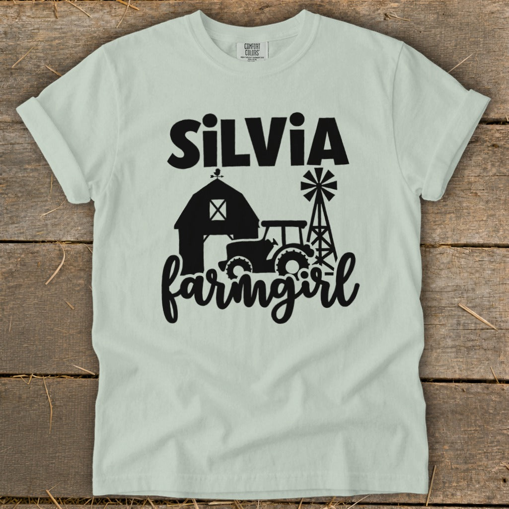 Light blue t-shirt with black farm graphic and text "Silvia farmgirl".