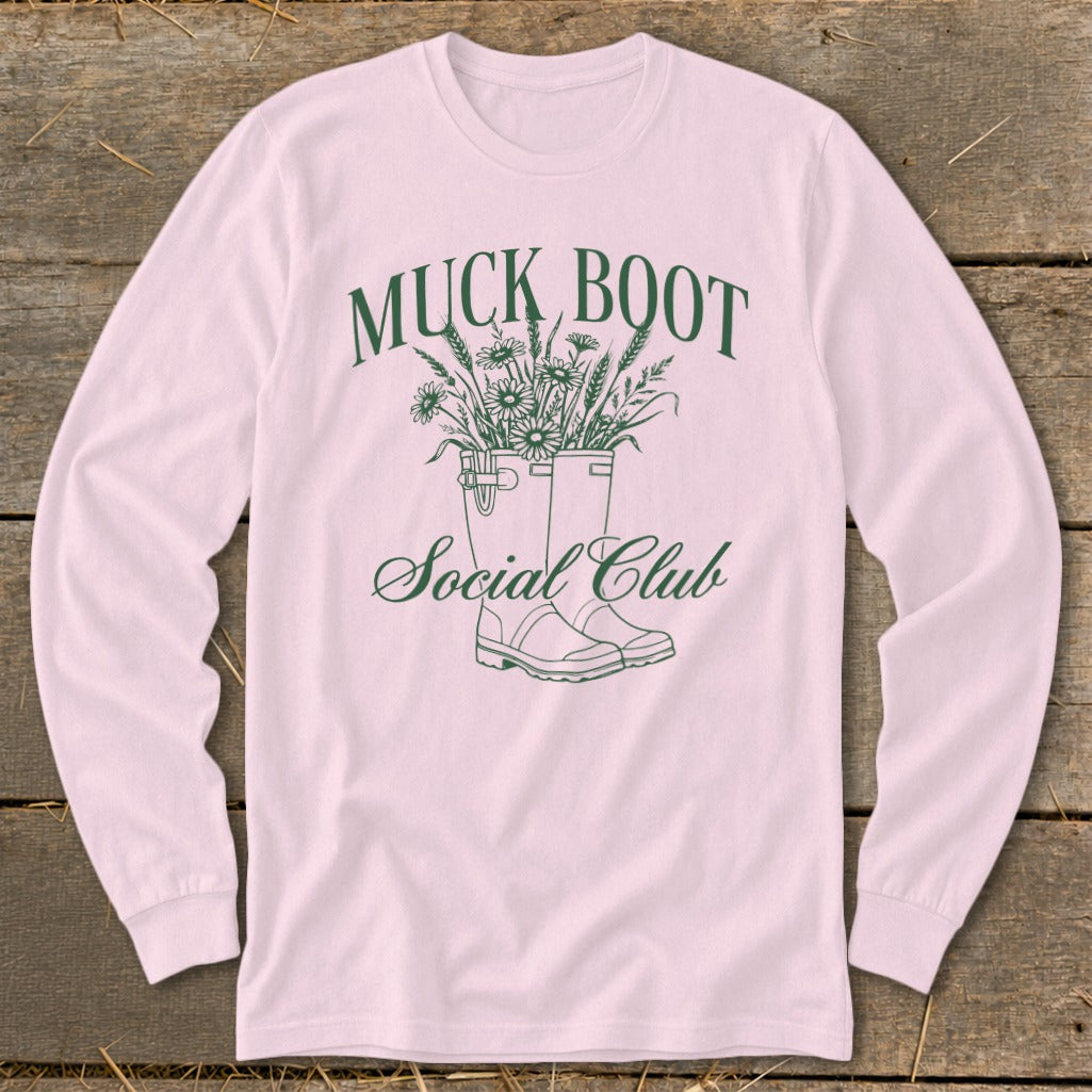 Pink long sleeve shirt with a graphic of muck boots and flowers, text says "Muck Boot Social Club".