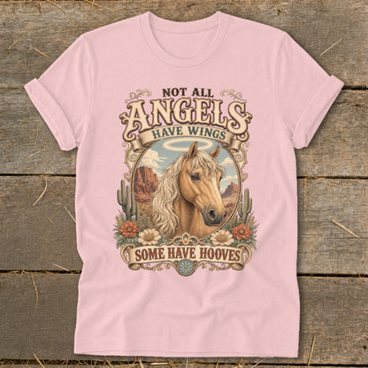 Pink t-shirt with a horse, desert landscape, and text "Not all angels have wings, some have hooves."