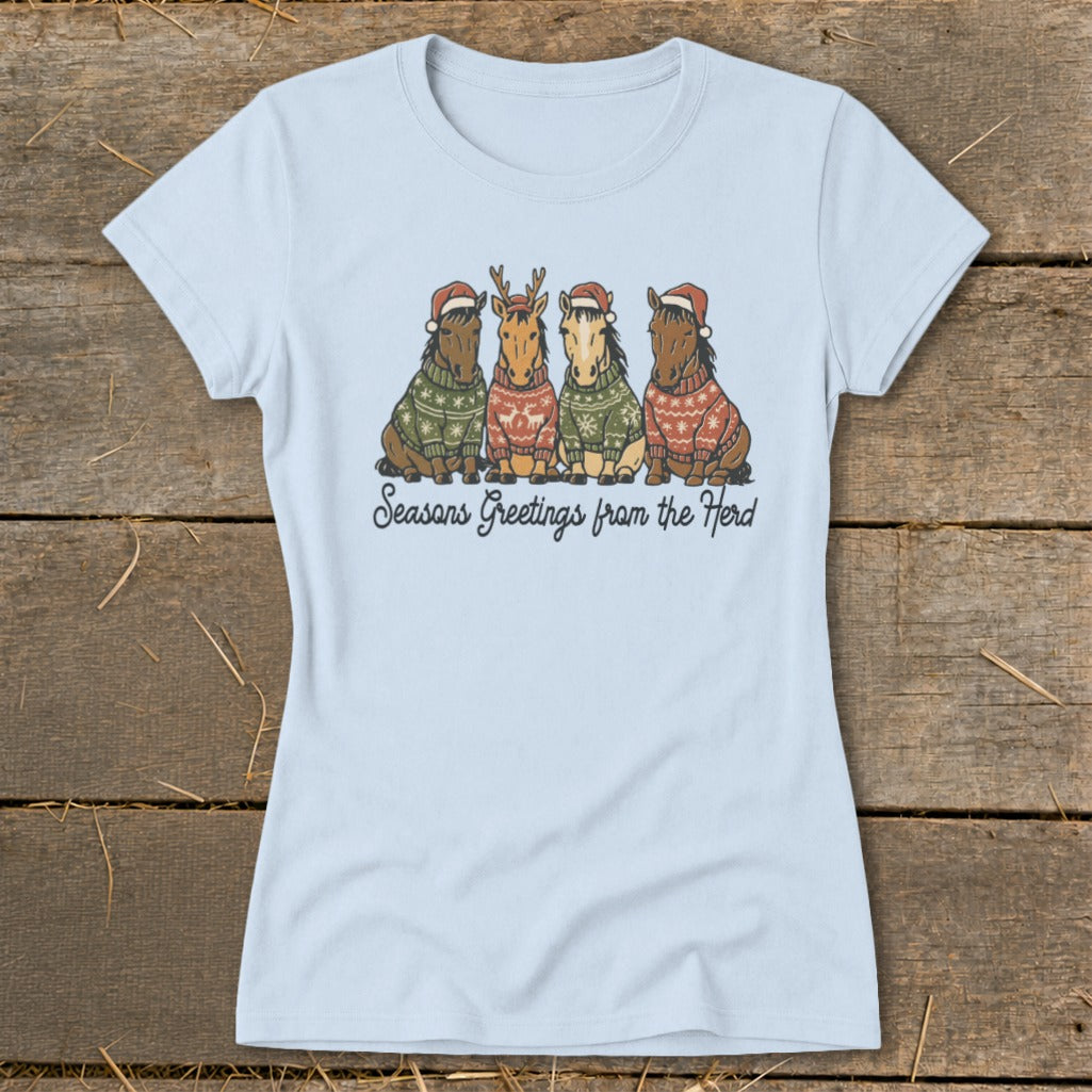 Four horses in Christmas sweaters and Santa hats, with text "Seasons Greetings from the Herd."