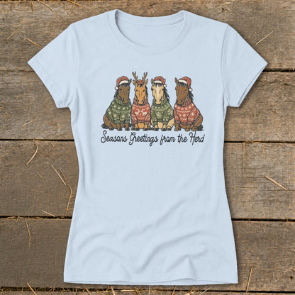 Four horses in Christmas sweaters and Santa hats, with text "Seasons Greetings from the Herd."