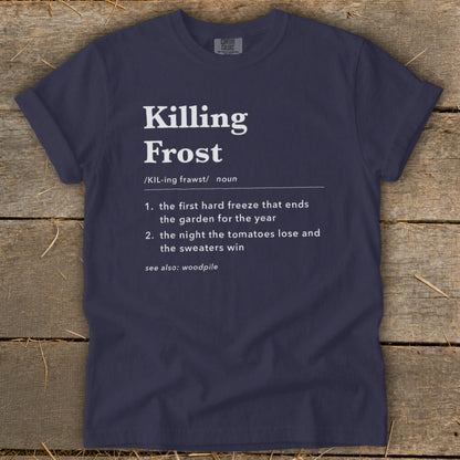 Dark navy blue t-shirt featuring white text with a dictionary definition of Killing Frost against a wooden background.