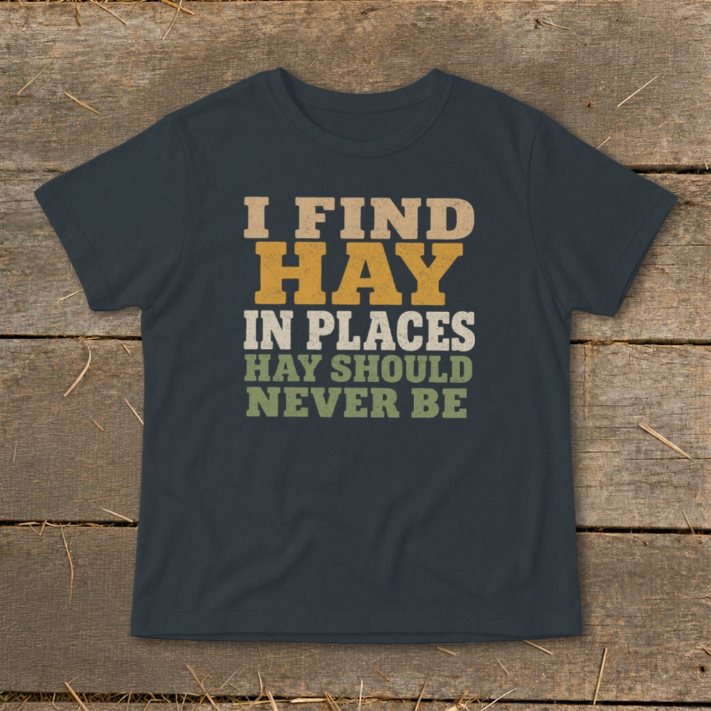 Dark t-shirt with text "I FIND HAY IN PLACES HAY SHOULD NEVER BE."