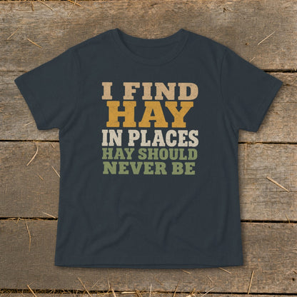 Dark t-shirt with text "I FIND HAY IN PLACES HAY SHOULD NEVER BE."