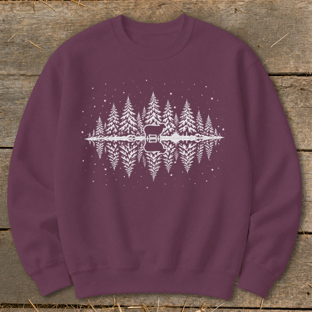 Burgundy sweatshirt with a white graphic of a sheep and pine trees reflected in water.