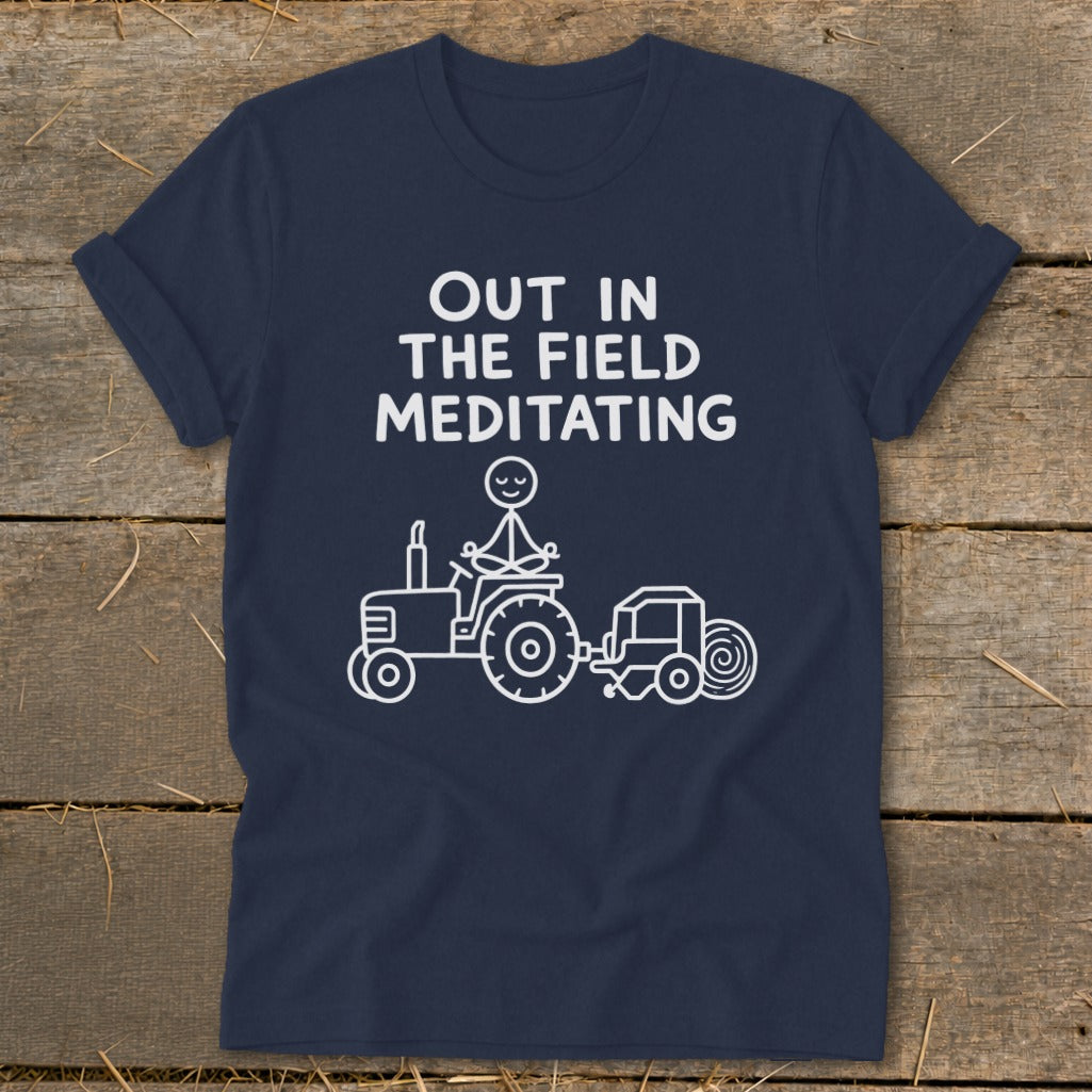 Navy t-shirt with "Out in the Field Meditating" and stick figure on tractor.
