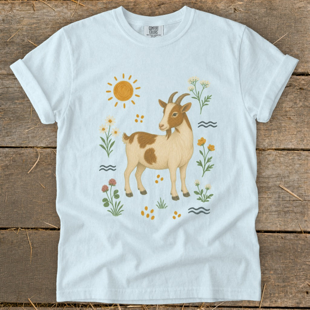 White t-shirt with a brown and white goat, sun, flowers, and waves design.
