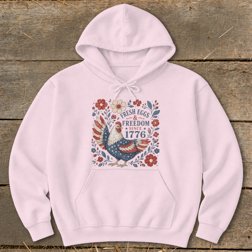 Pink hoodie with patriotic chicken design and "Fresh Eggs & Freedom Since 1776" text.