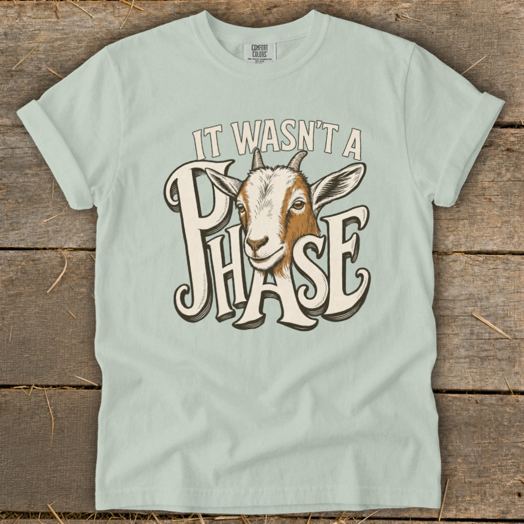 Goat with text "It wasn't a phase" on a light green t-shirt.