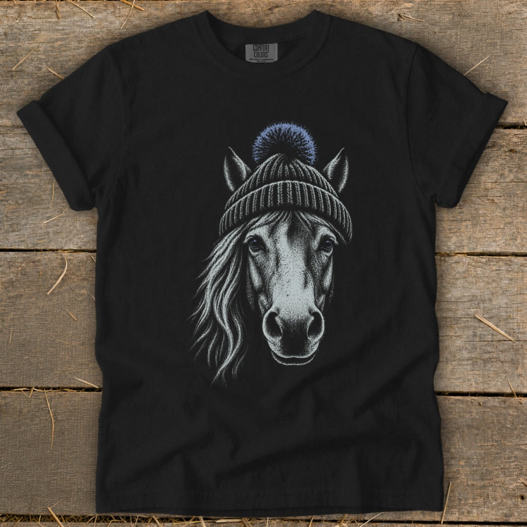 Black t-shirt with a white sketch of a horse wearing a blue pom-pom beanie.