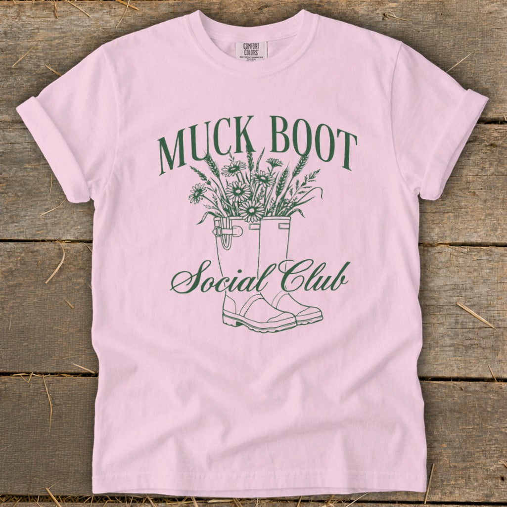 Pink t-shirt with "Muck Boot Social Club" text and line art of boots with flowers.