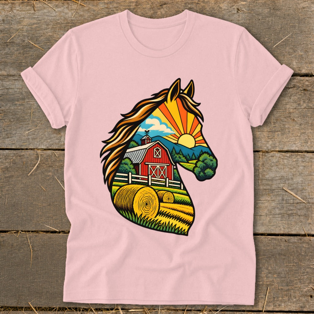 A pink t-shirt featuring a graphic illustration of a horse head silhouette filled with a farm landscape.