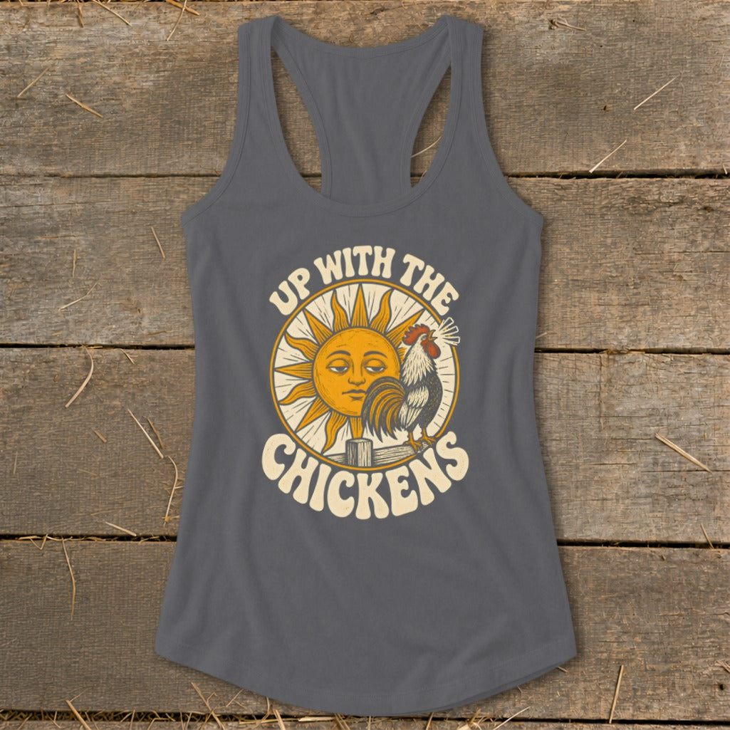 A charcoal gray women's racerback tank top featuring a graphic of a sun, rooster, and the text Up With The Chickens.