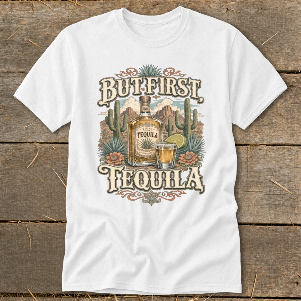 White t-shirt with "But First Tequila" text, bottle, shot glass, cacti, and mountains.