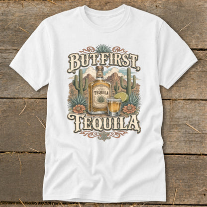 White t-shirt with "But First Tequila" text, bottle, shot glass, cacti, and mountains.
