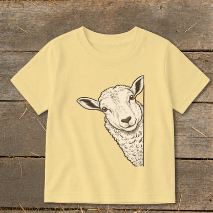 Cream t-shirt with a sheep peeking from the side of the graphic.