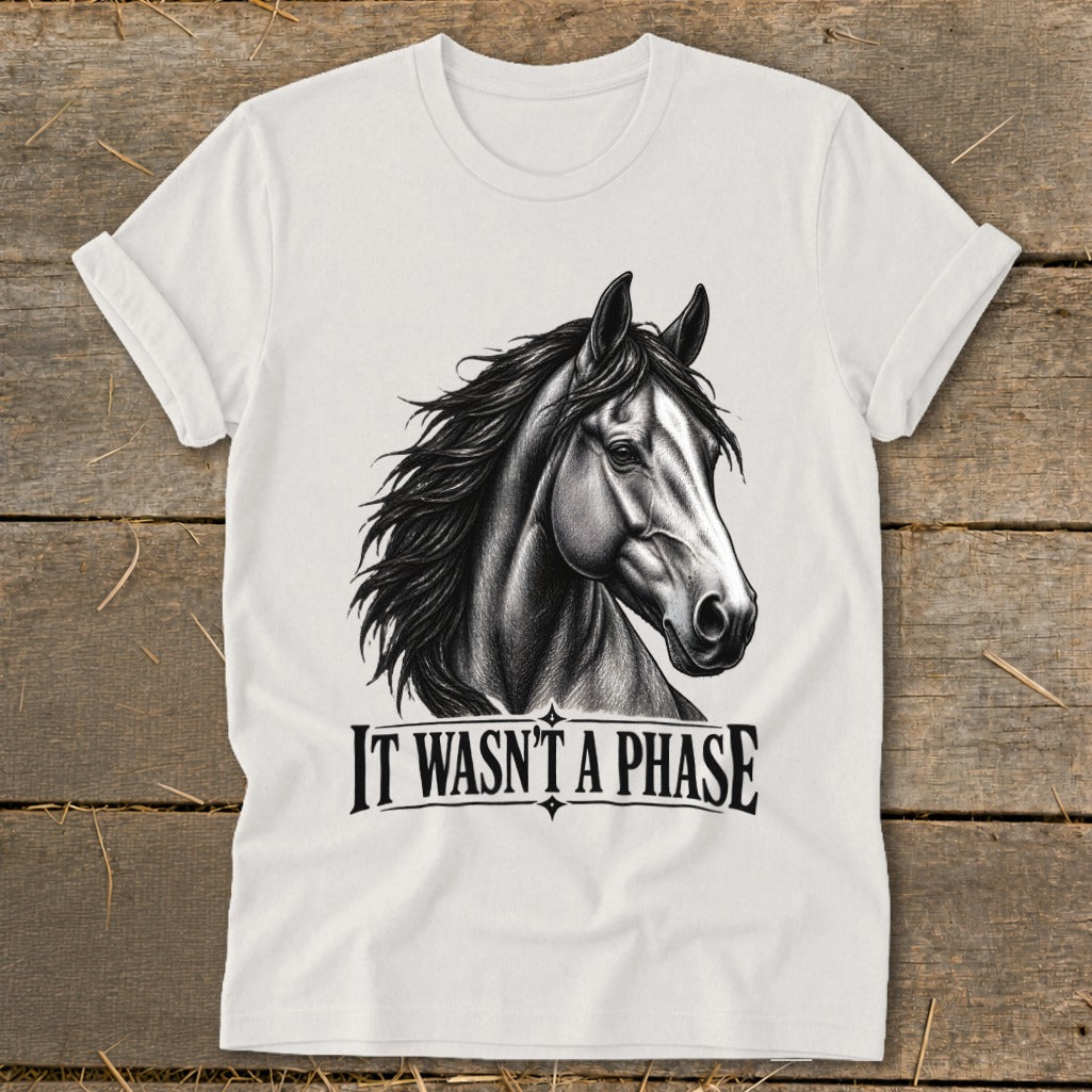 White t-shirt with black sketch of a horse head and text "IT WASN'T A PHASE."