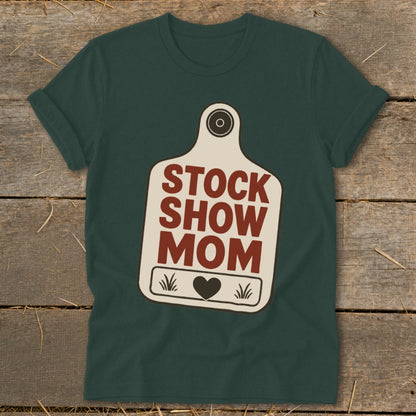 Dark green t-shirt with "STOCK SHOW MOM" text and heart on a tag graphic.
