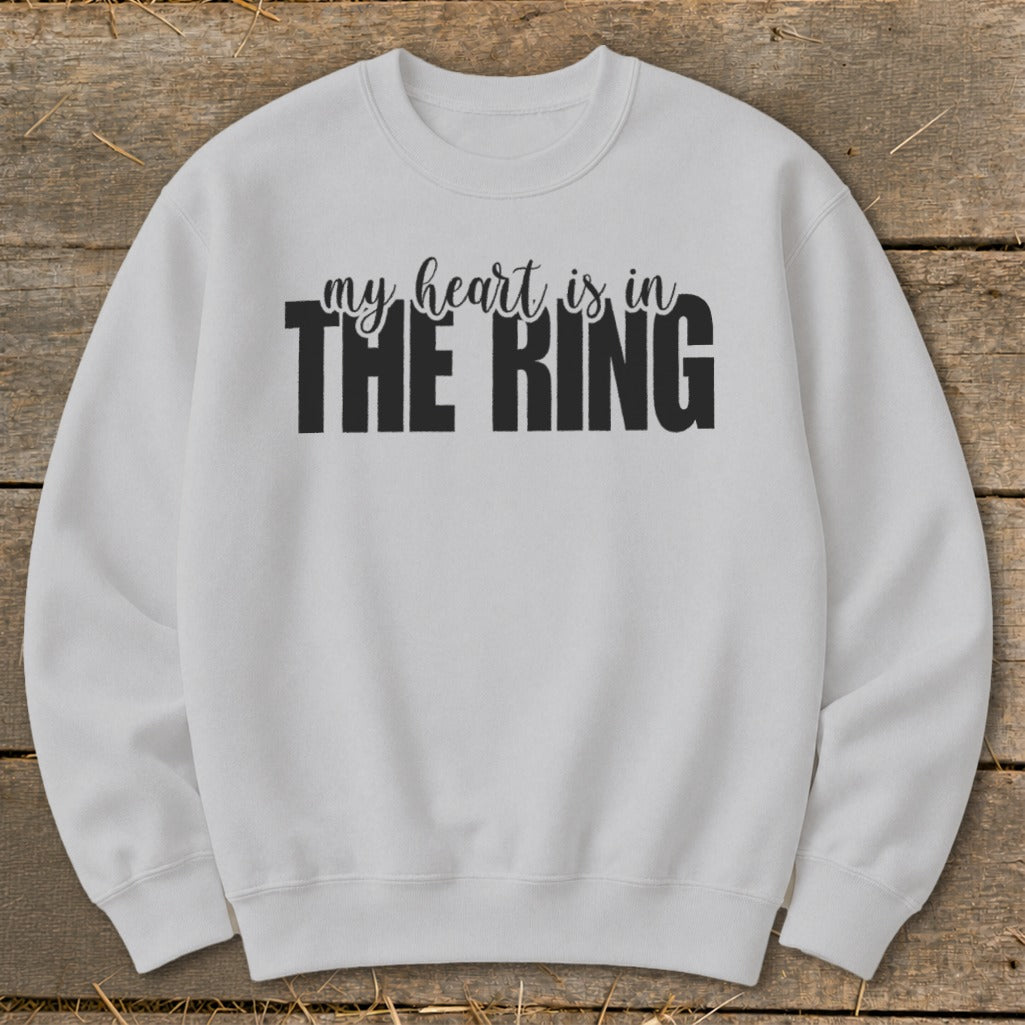 White sweatshirt with black text reading "my heart is in THE RING".