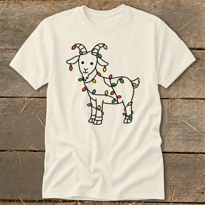 Cream t-shirt with a black line drawing of a goat wrapped in colorful Christmas lights.