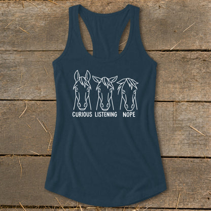 Dark blue women's racerback tank top featuring three white horse head outlines with captions reading Curious, Listening, and Nope.