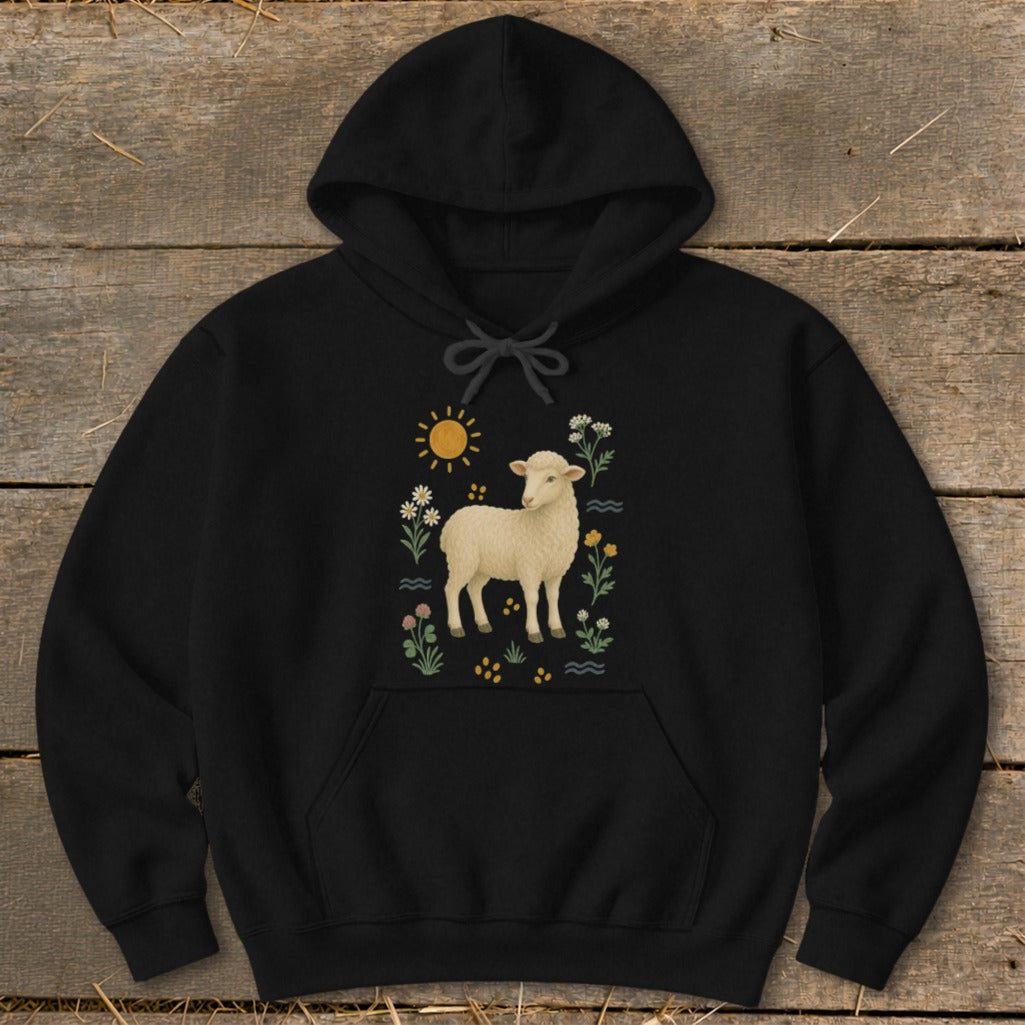 Black hoodie with a white sheep among flowers and a sun graphic.