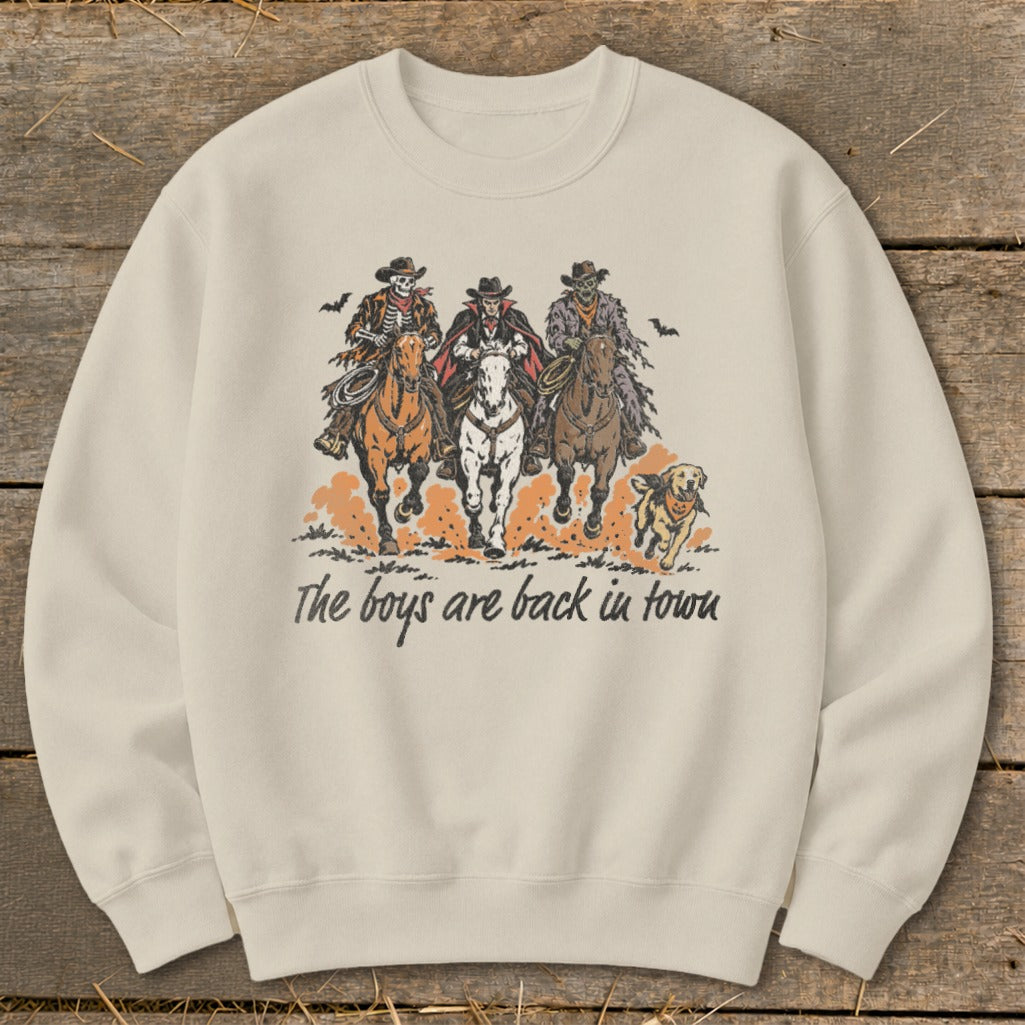 Three skeletal figures on horses and a dog with text "The boys are back in town."
