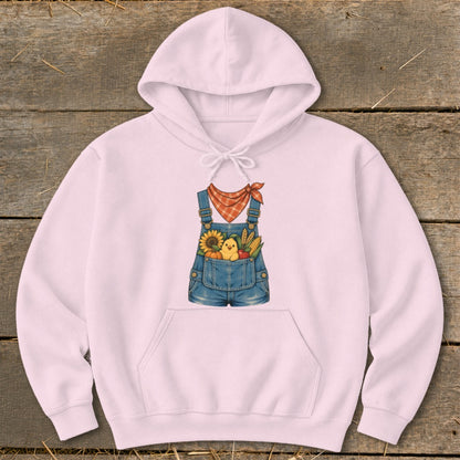 Pink hoodie with a graphic of denim overalls filled with a chick, sunflower, pumpkin, and corn.