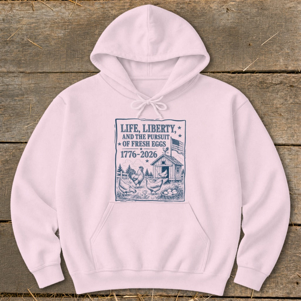 Pink hoodie with graphic of chickens, barn, eggs, and text "Life, Liberty, and the Pursuit of Fresh Eggs".