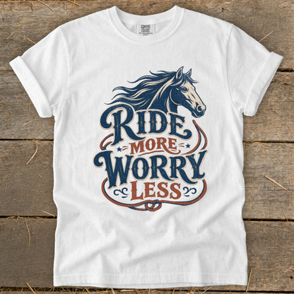 White t-shirt with "Ride More Worry Less" text and a horse graphic.