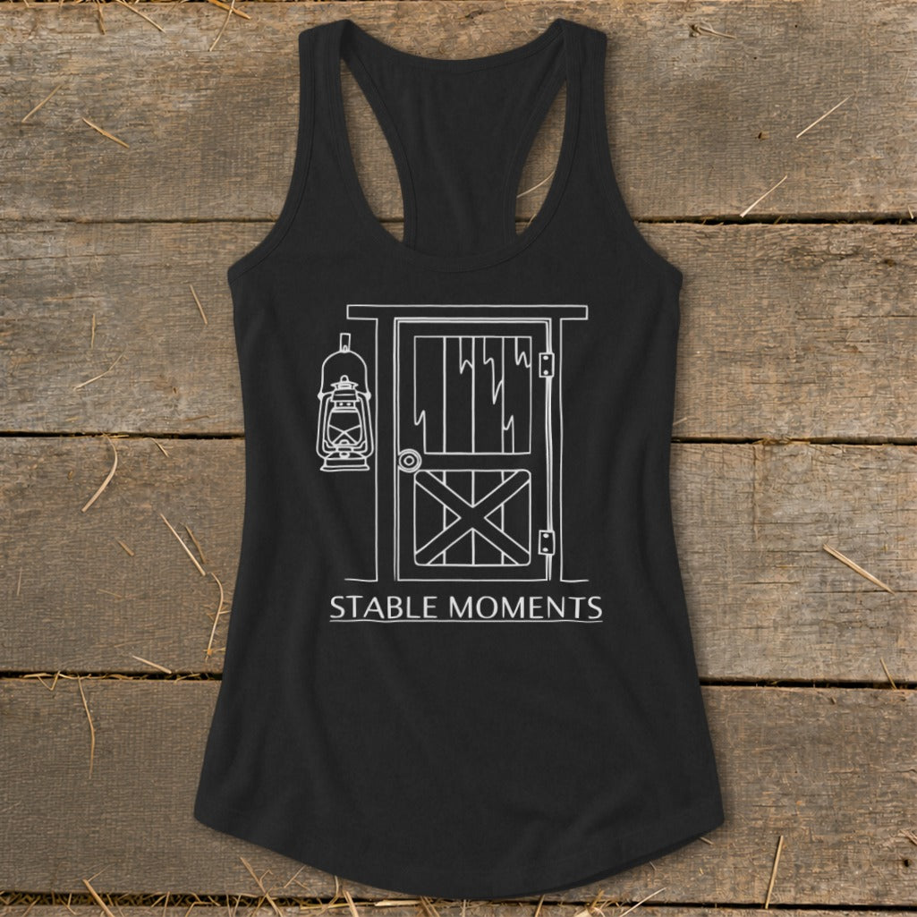 Black tank top with white line drawing of barn door, lantern, and text "STABLE MOMENTS".