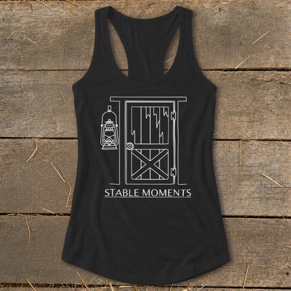 Black tank top with white line drawing of barn door, lantern, and text "STABLE MOMENTS".