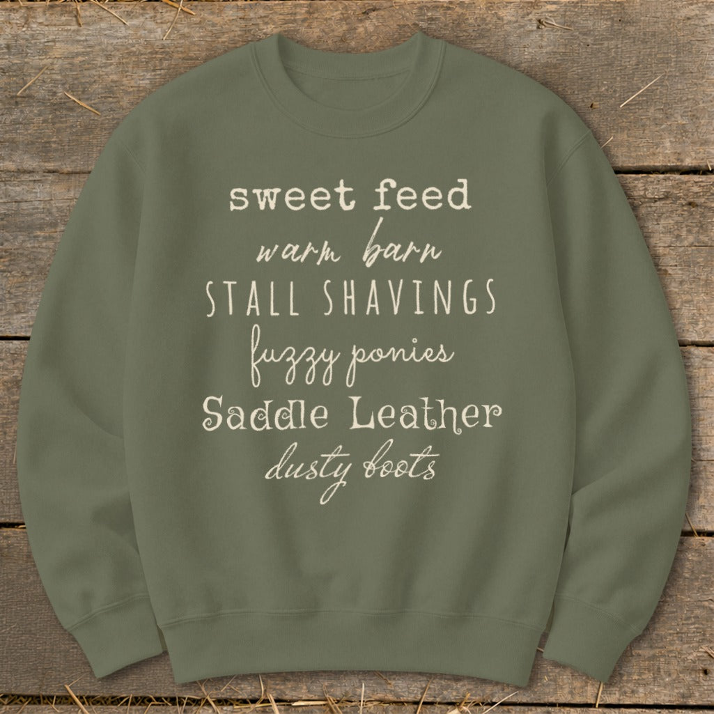 Olive sweatshirt with text: sweet feed, warm barn, stall shavings, fuzzy ponies, saddle leather, dusty boots.