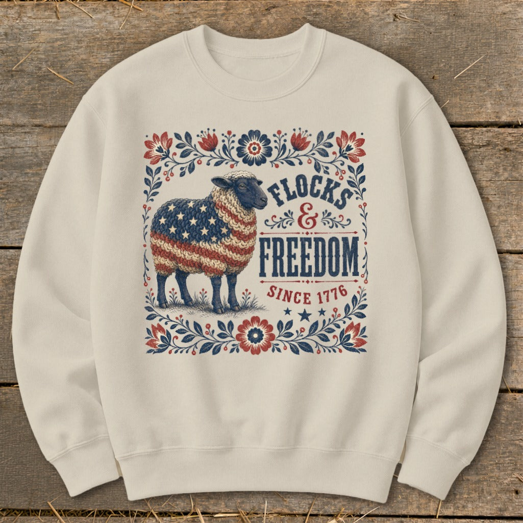 Sheep with American flag wool, surrounded by floral border, with text "Flocks & Freedom Since 1776".