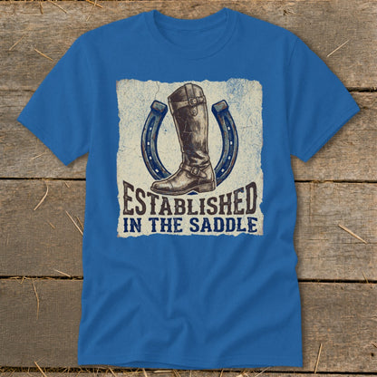 Blue t-shirt with a riding boot and two horseshoes, reading "Established in the Saddle."