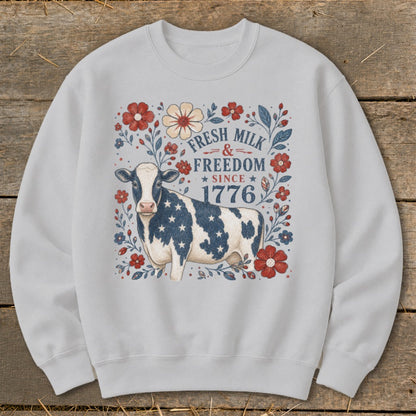 Cow with stars and stripes, surrounded by flowers and text "Fresh Milk & Freedom Since 1776".