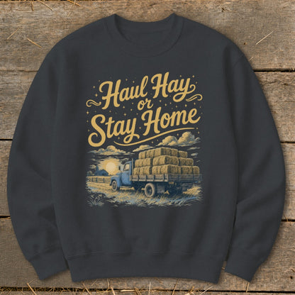 "Haul Hay or Stay Home" graphic on a dark grey crewneck sweatshirt with a vintage truck.