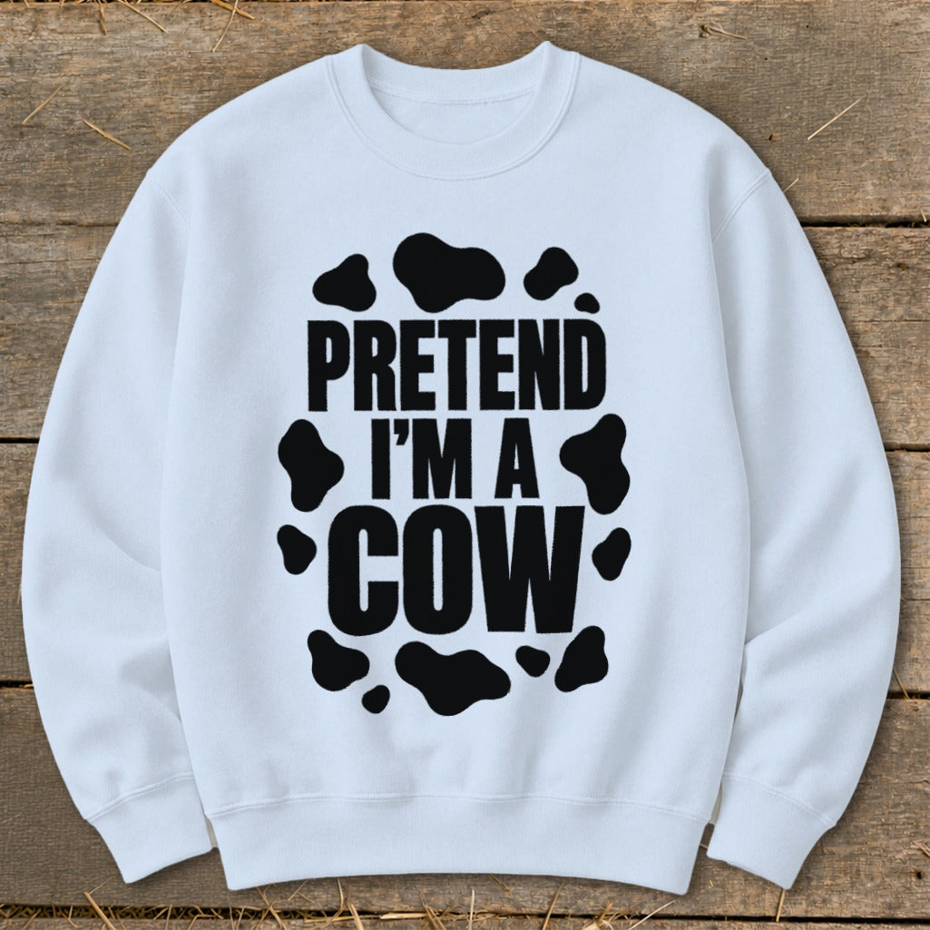 White sweatshirt with black text "PRETEND I'M A COW" surrounded by cow spots.