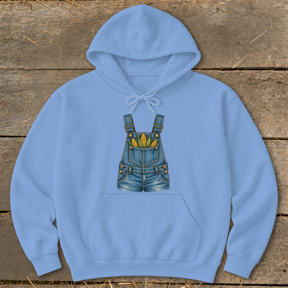 Light blue hoodie with a graphic of denim overalls filled with corn on the cob.