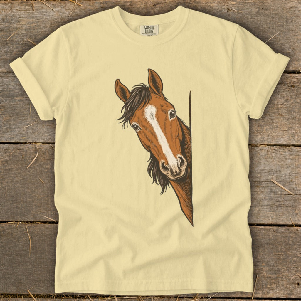 Yellow t-shirt with a drawing of a brown horse peeking from the side.