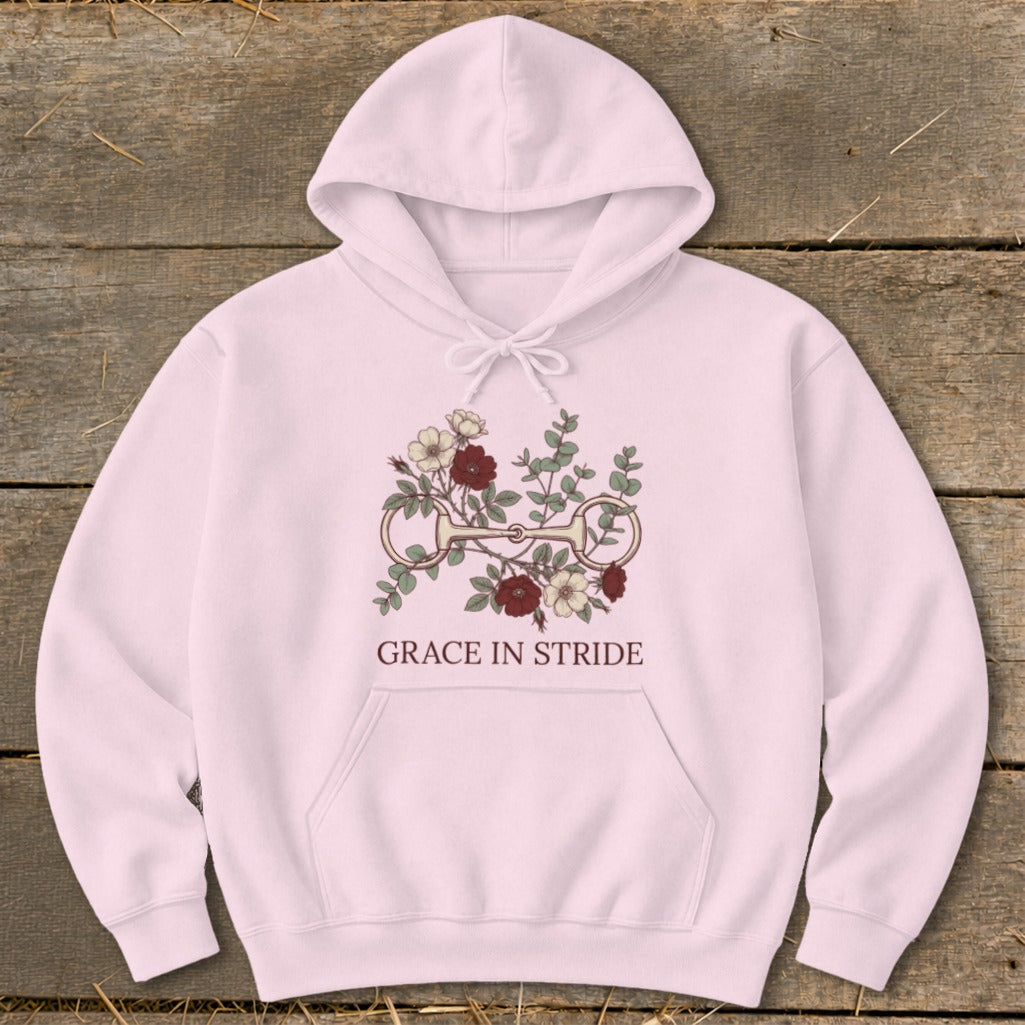 Pink hoodie with floral horse bit graphic and text "GRACE IN STRIDE".