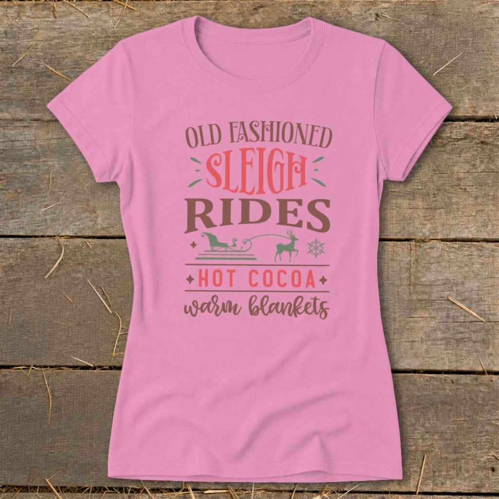 Pink t-shirt with text: Old Fashioned Sleigh Rides, Hot Cocoa, Warm Blankets.